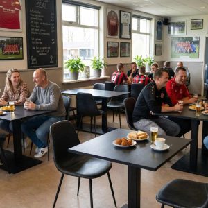 Super-Seat | Houten eiken tafels, zwart metalen onderstel, mix van stoelen en barkrukken in modern café. | Horecameubilair