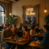 Super-Seat | Diners ontspannen in een gezellig restaurant met warme verlichting en kamerplanten | Stoelen van donker hout met groene bekleding, tafels van licht eiken, barkrukken zwart staal en leer |. | Horecameubilair