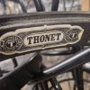 Super-Seat | Close-up zwart metalen stoelframe "THONET" label | Zwart metalen frame, sierlijke vormen, verweven poten; vintage Thonet-stijl. | Horecameubilair