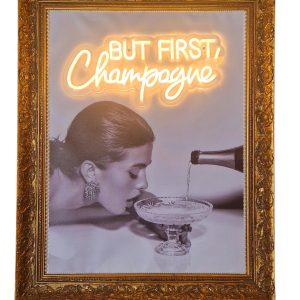 Super-Seat | Een ingelijste zwart-wit foto toont een vrouw met een coupe... | Antieke houten lijst (80x65cm), zwart-wit foto, neon CHAMPAGNE. | Horecameubilair