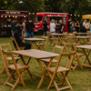 Super-Seat |Retro horeca design stapelstoelen fluweel mokka Fluwelen mokkakleurige stapelstoelen buiten op gras tussen bomen. | Horecameubilair